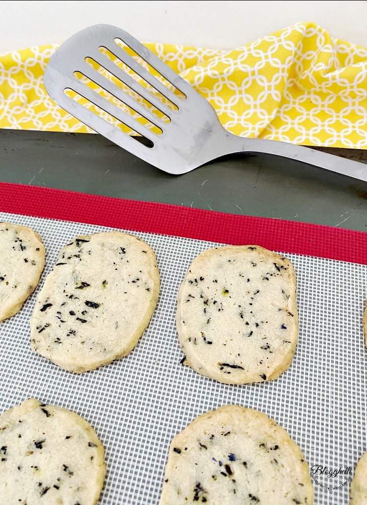 Blueberry earl grey cookies on a silicone mat.