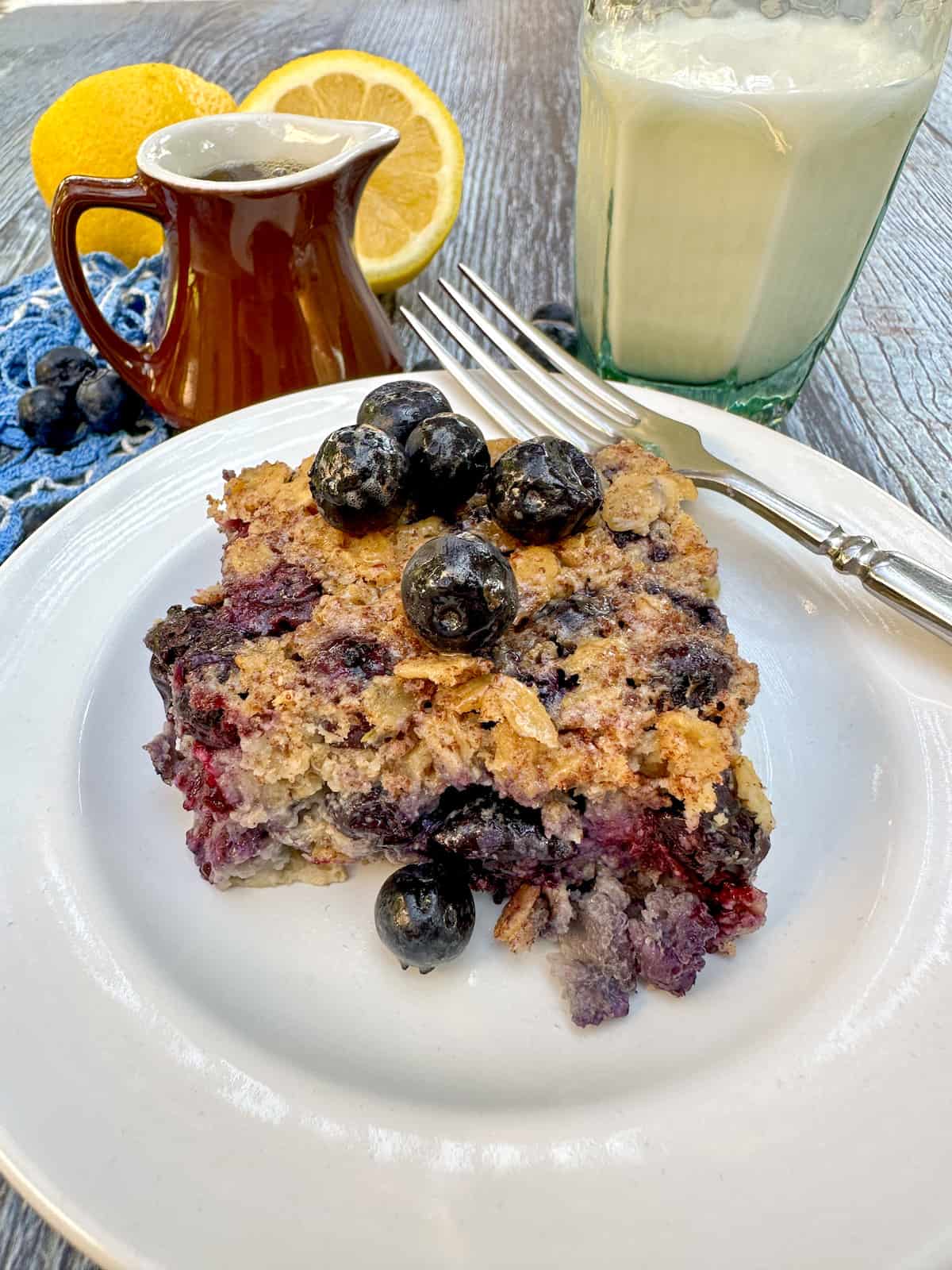 Serving of blueberry baked oatmeal on a white plate.