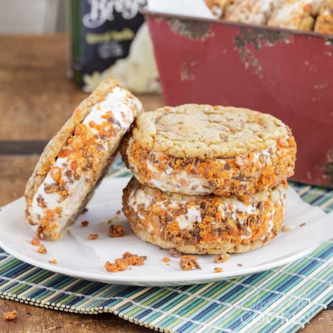 Butterfinger ice cream sandwiches on a white plate.