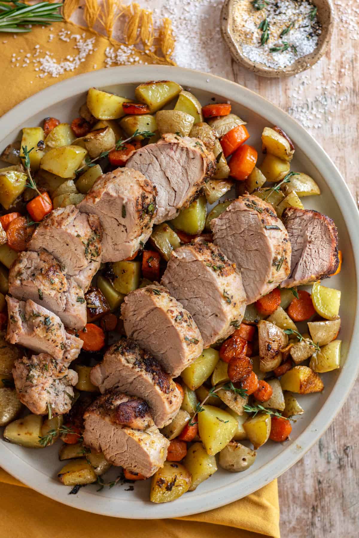 Pork tenderloin with potatoes and carrots on a platter.