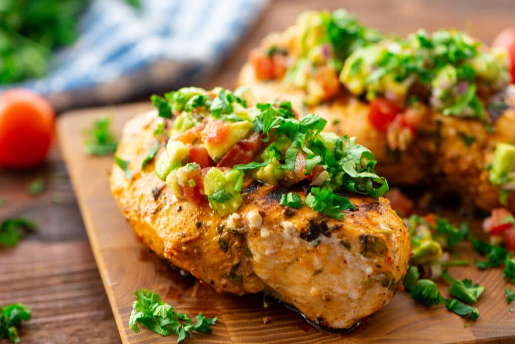 Cilantro lime grilled chicken on a cutting board.