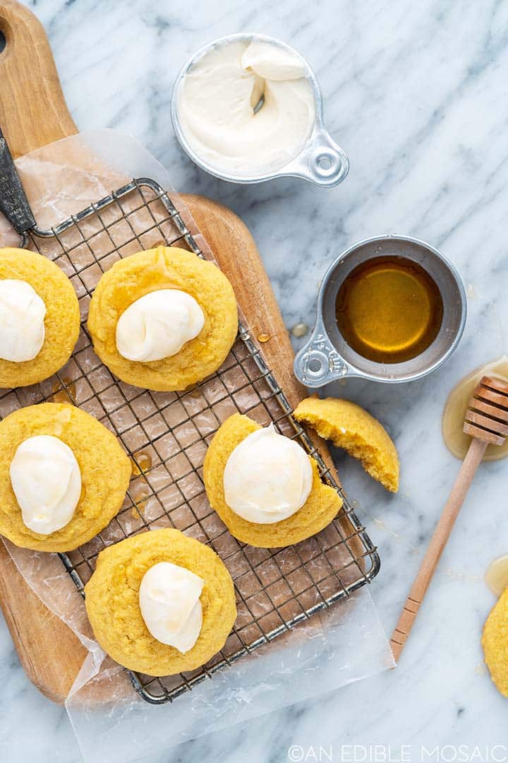 Cornbread cookies on a old fashioned cooling rack surrounded by ingredients.