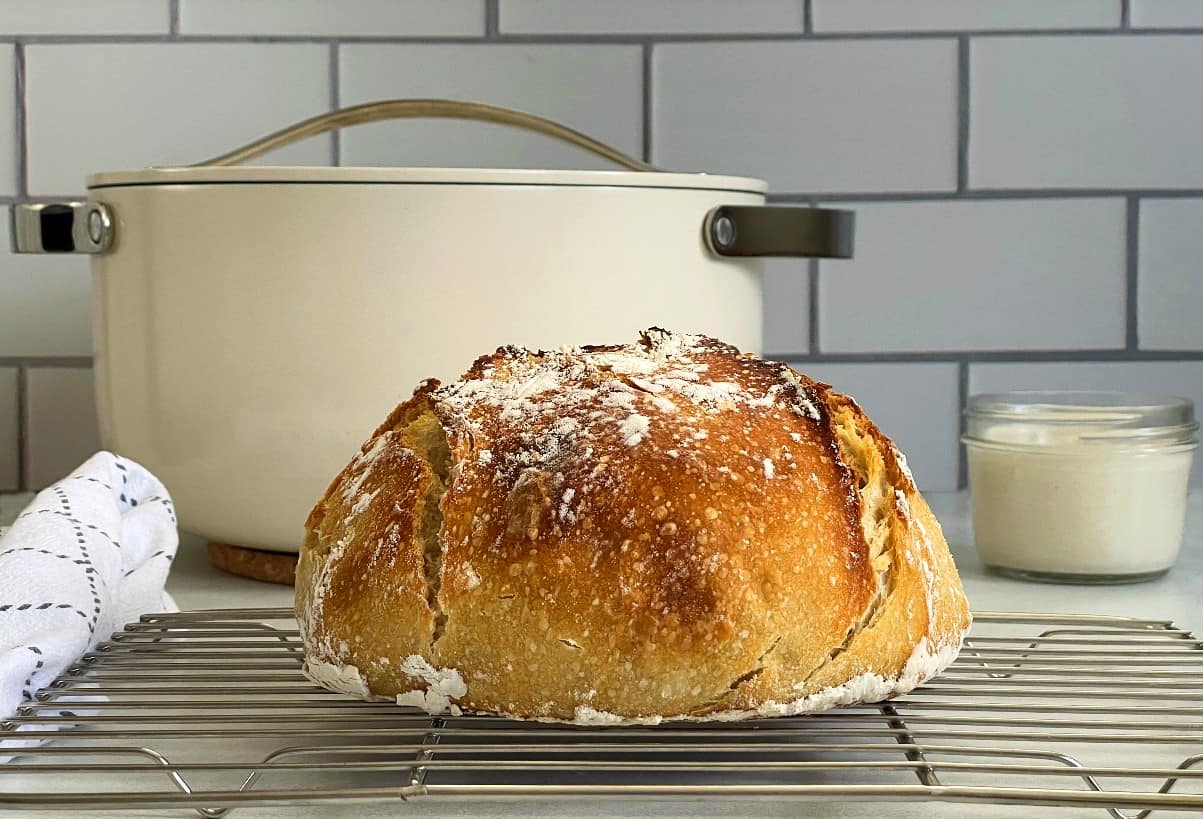 Dutch oven sourdough bread on a cooling rack.