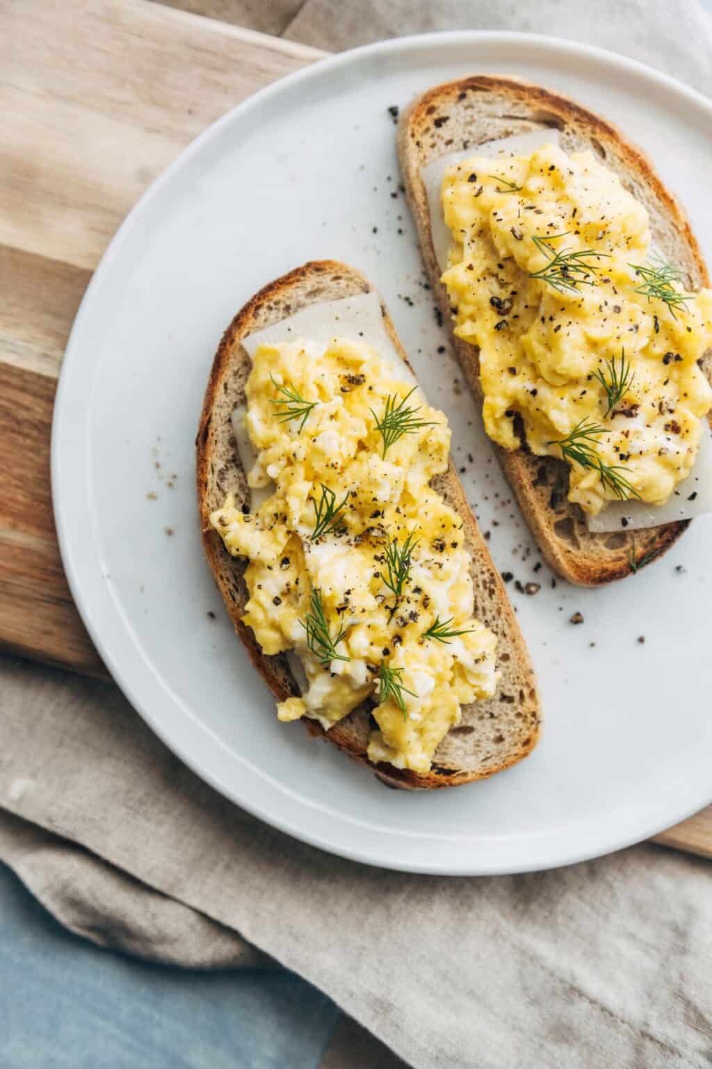 Scrambled egg and cheese on a white plate.