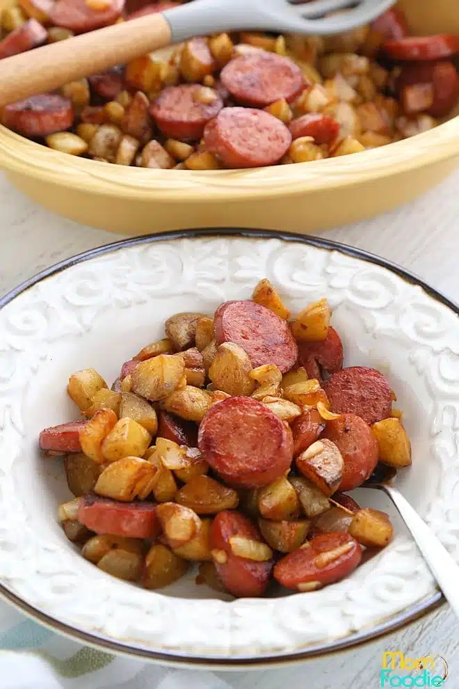 Kielbasa with potatoes in a white bowl.