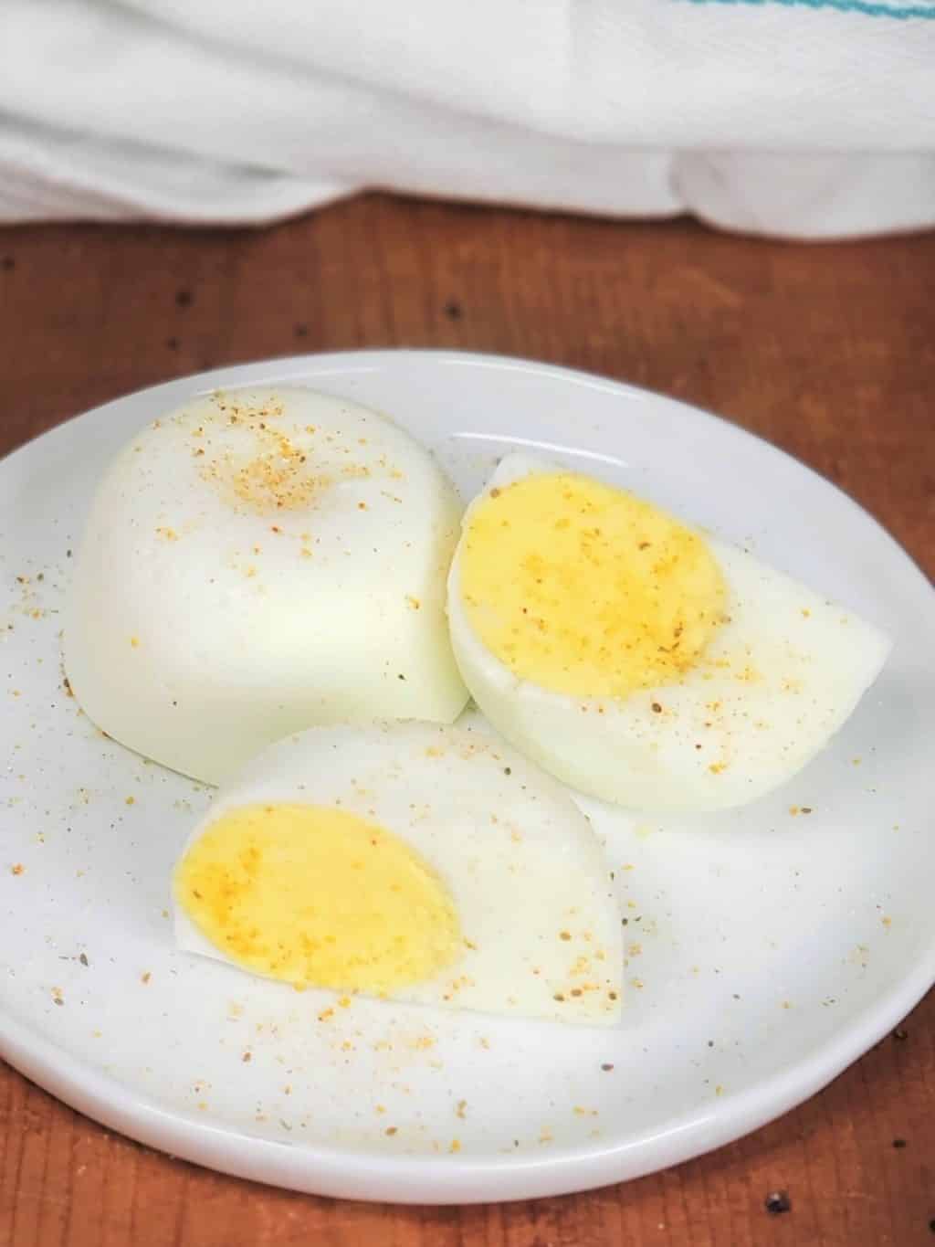 Hard boiled eggs on a white plate.