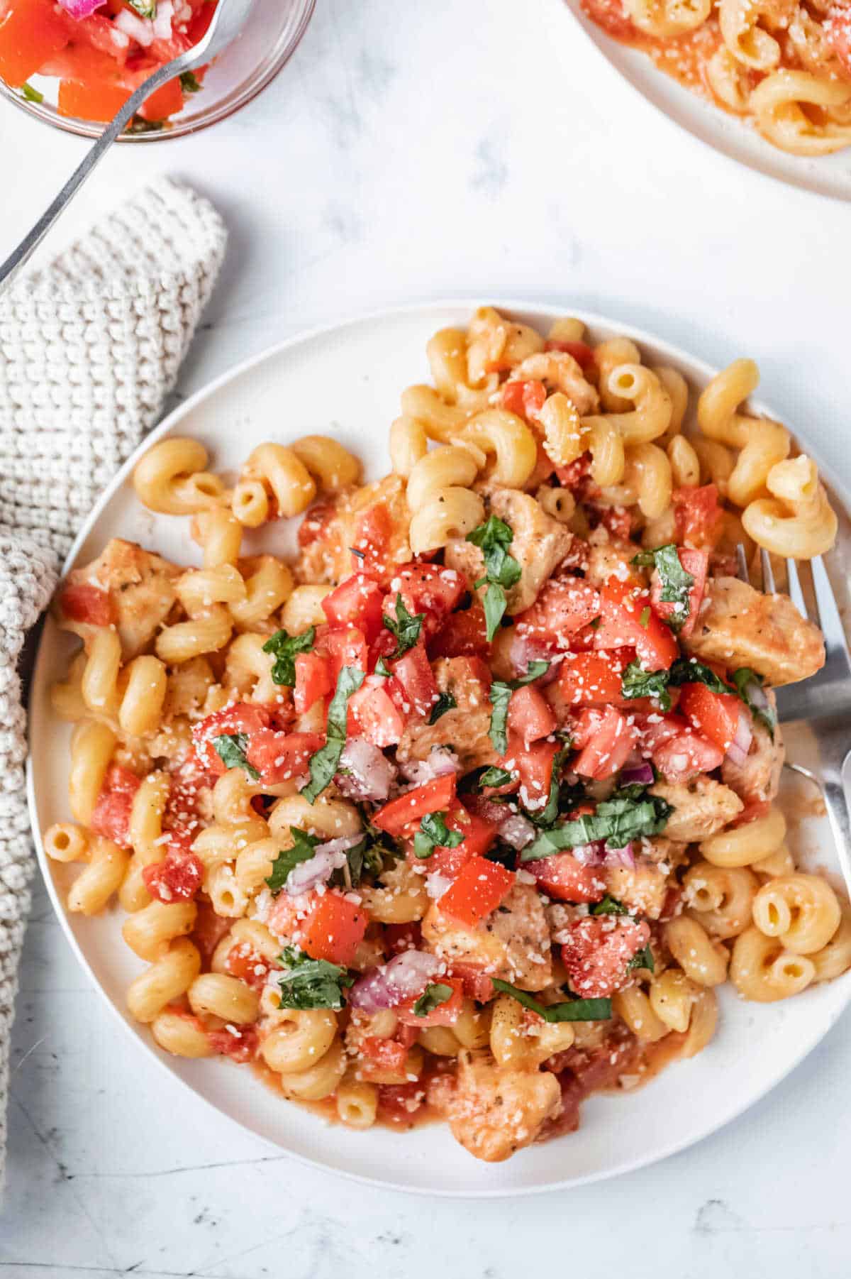 Instant pot bruschetta chicken pasta recipe on a white plate.