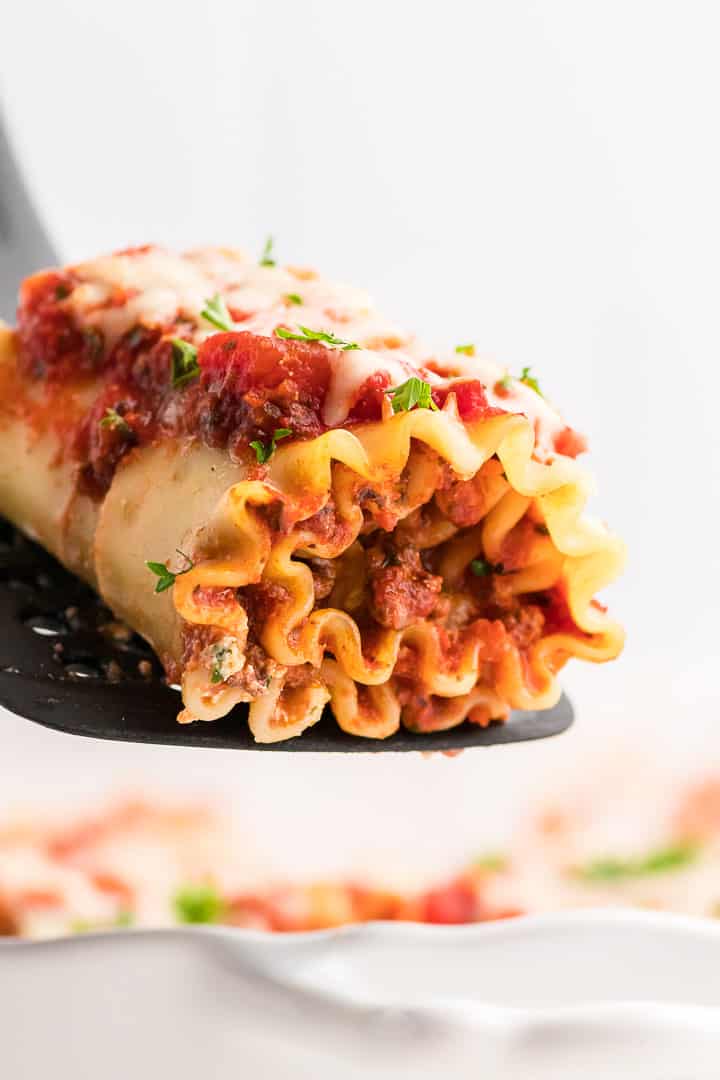 Lasagna roll ups on a spatula.