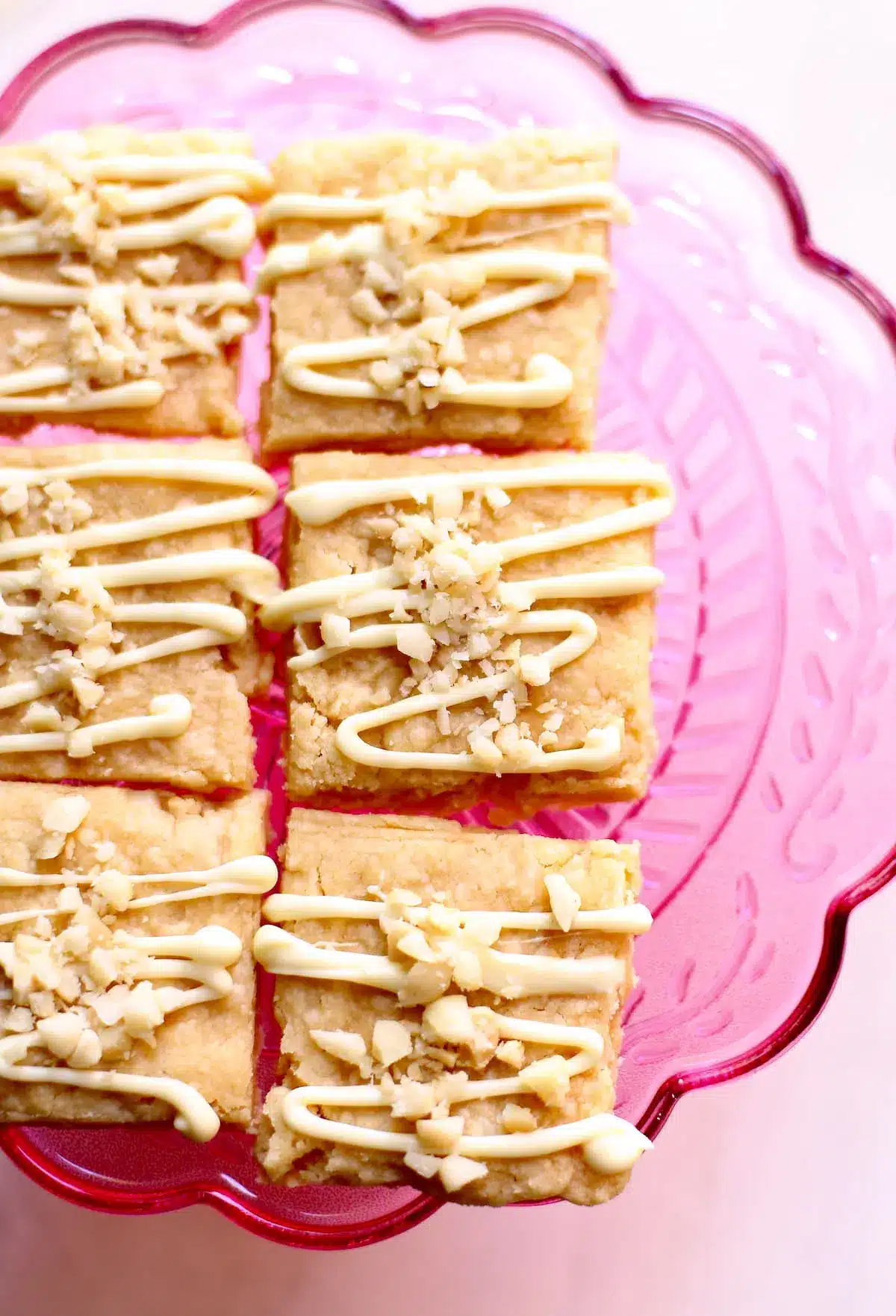 Macadamia nut shortbread cookies on a pink plate.