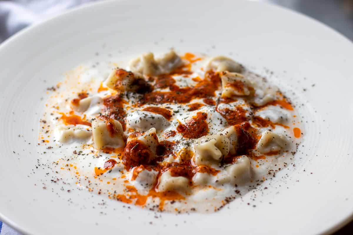 Turkish ravioli in a white bowl.