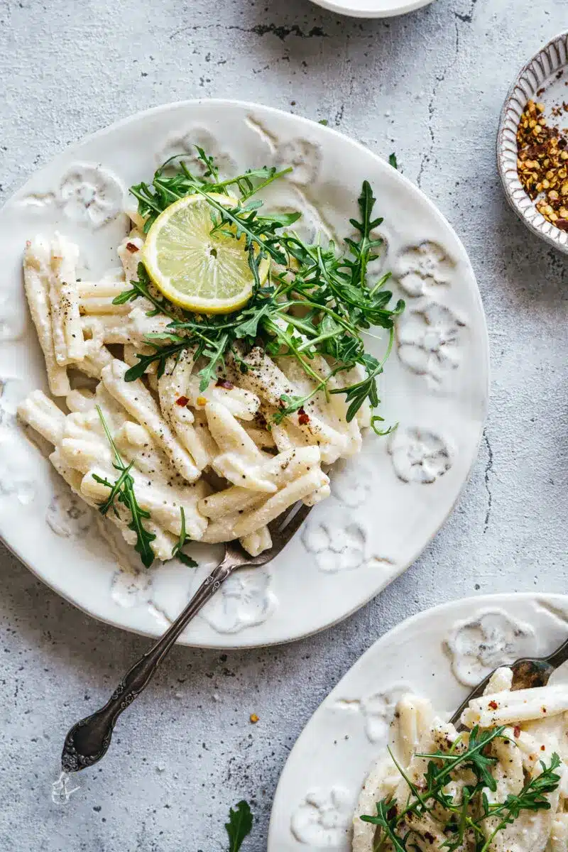 Creamy one pot lemon ricotta pasta on a decorative white plate.