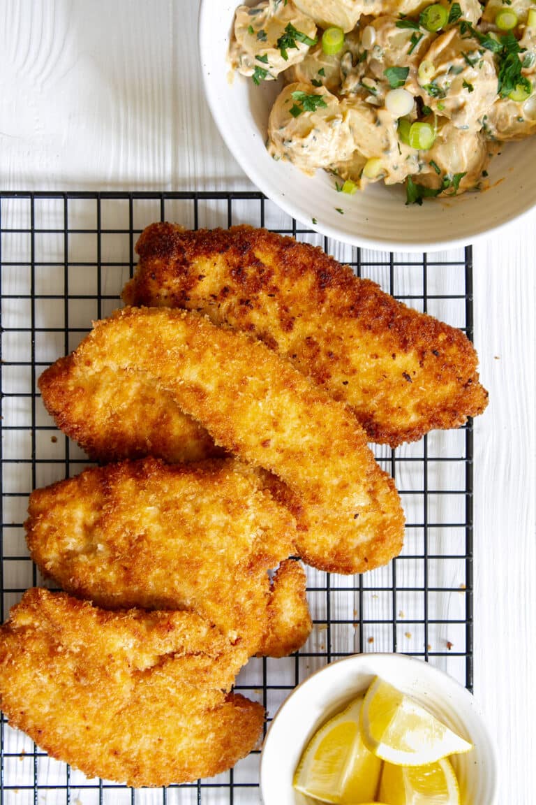 Crispy fried panko crusted chicken breast on a cooling rack.