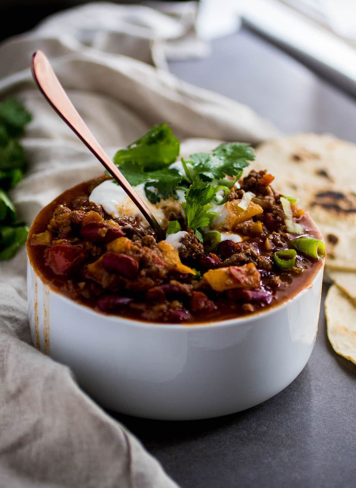 Peach whiskey chili in a white bowl.