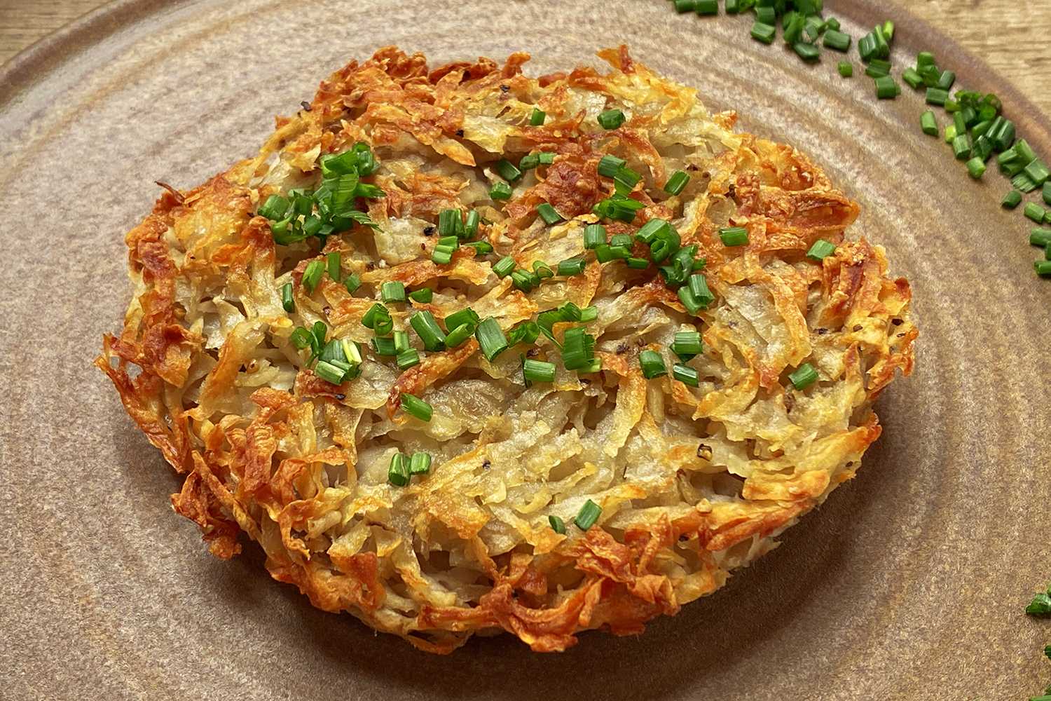 Potato rosti on a brown surface.