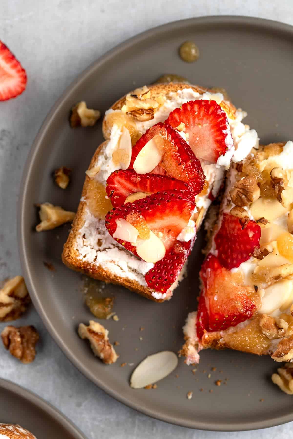 Ricotta honey toast on a dark plate.