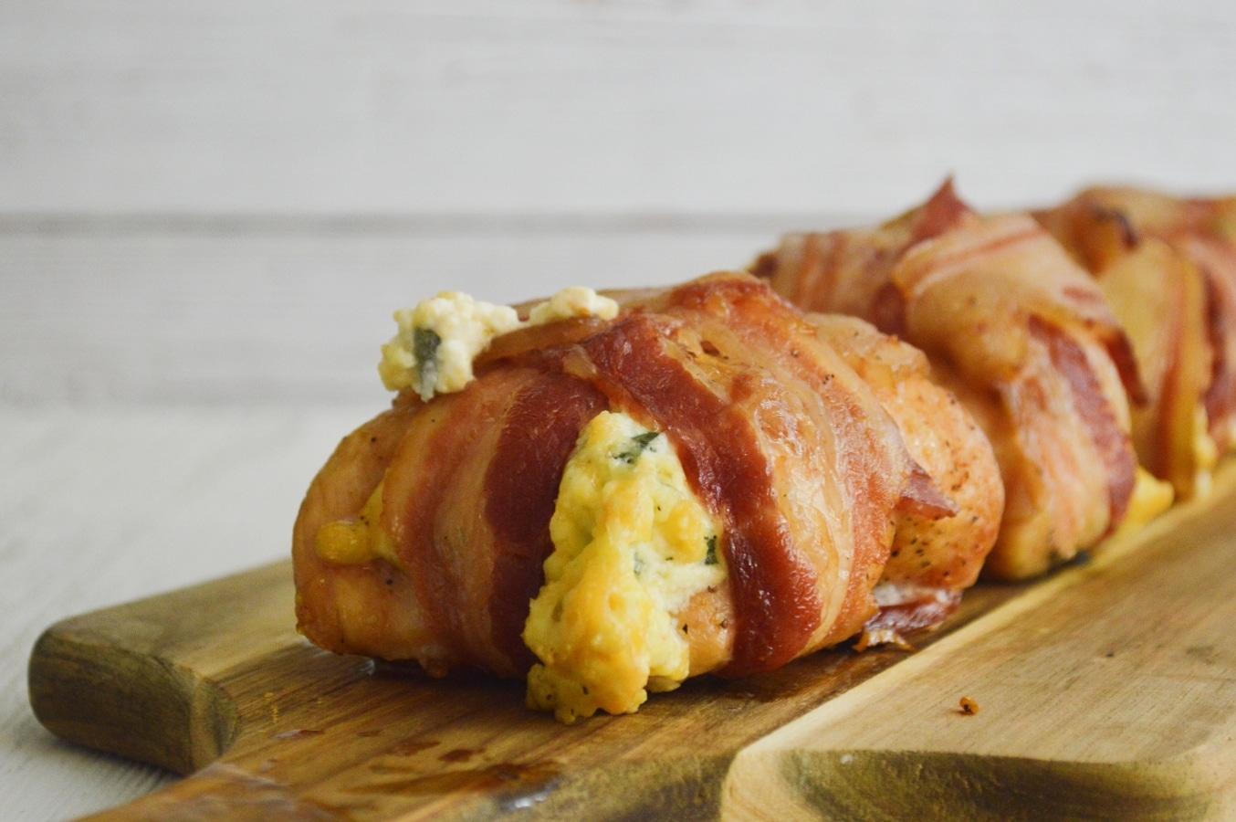 Chicken stuffed with poblano pepper cheese on a cutting board.