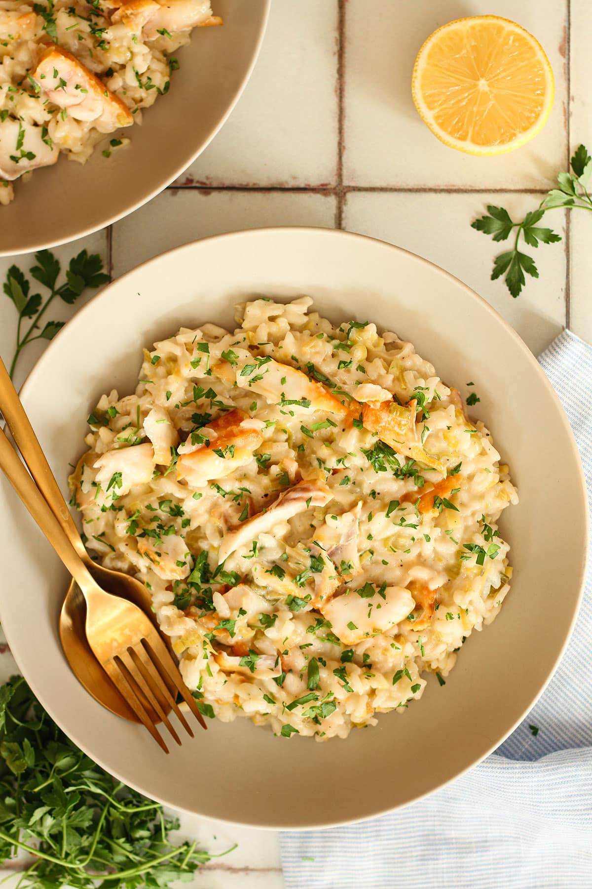 Creamy smoked haddock and leek risotto in a bowl with fork and spoon.