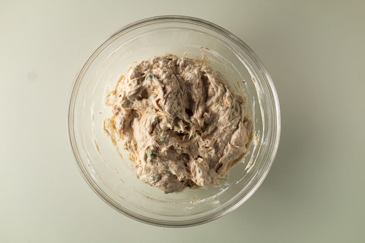Mixed smoked salmon dip in clear bowl.