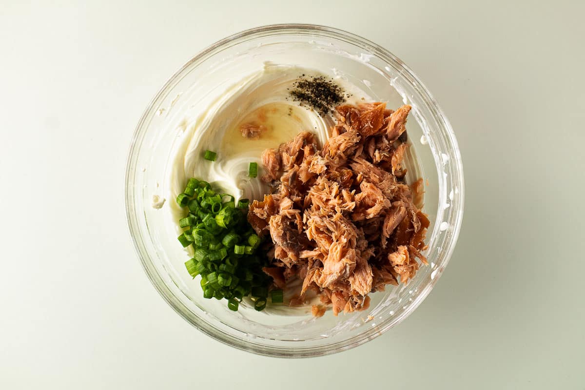 5 ingredient smoked salmon dip ingredients in a clear bowl.