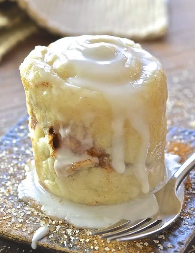 Cinnamon roll mug cake with a fork.