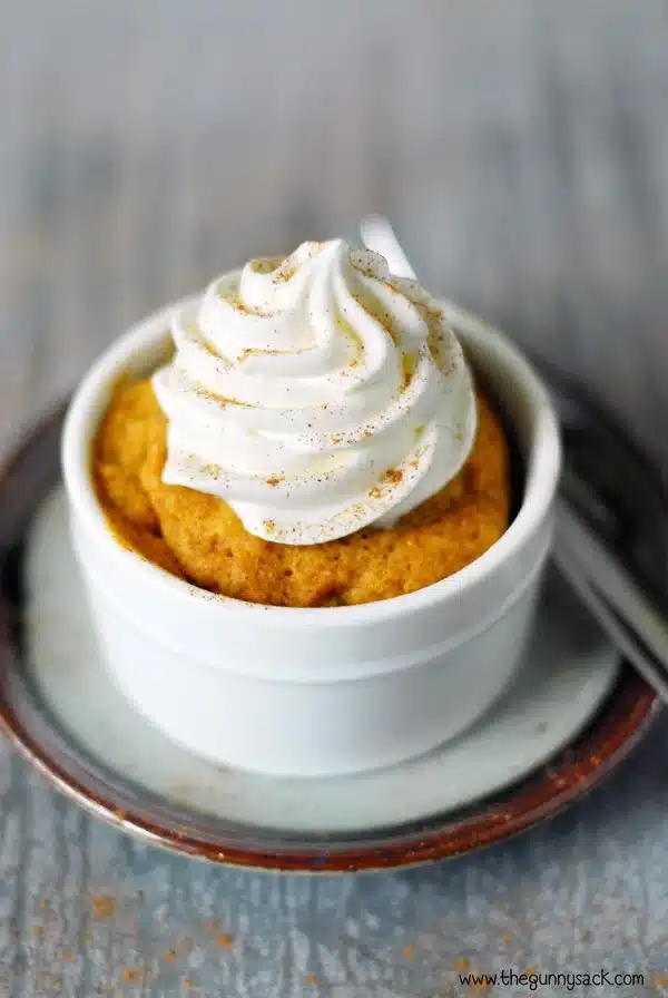 Pumpkin mug cake on a saucer.