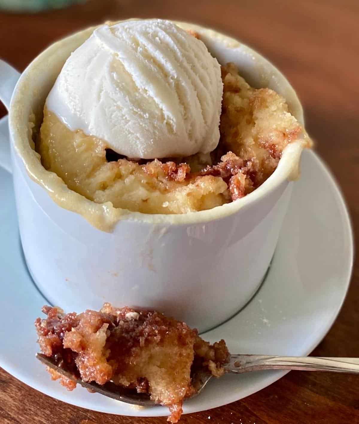 Toblerone mug cake on a saucer with a fork.