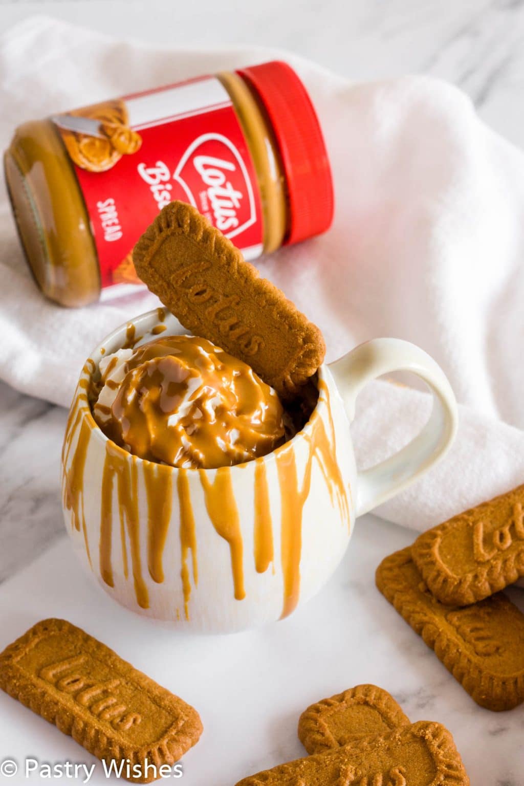 Biscoff mug cake with more cookies in the background.