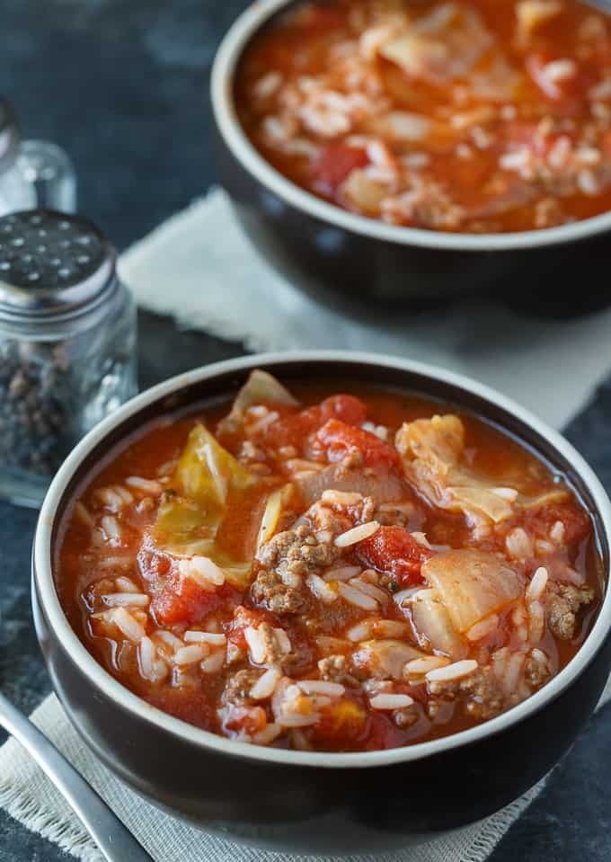 Slow cooker cabbage roll soup recipe in a dark bowl.