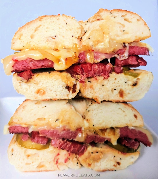 Corned beef bagel sandwich cut in half and stacked.