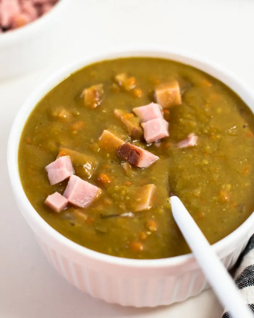 Crockpot split pea soup with ham in a white ramekin.