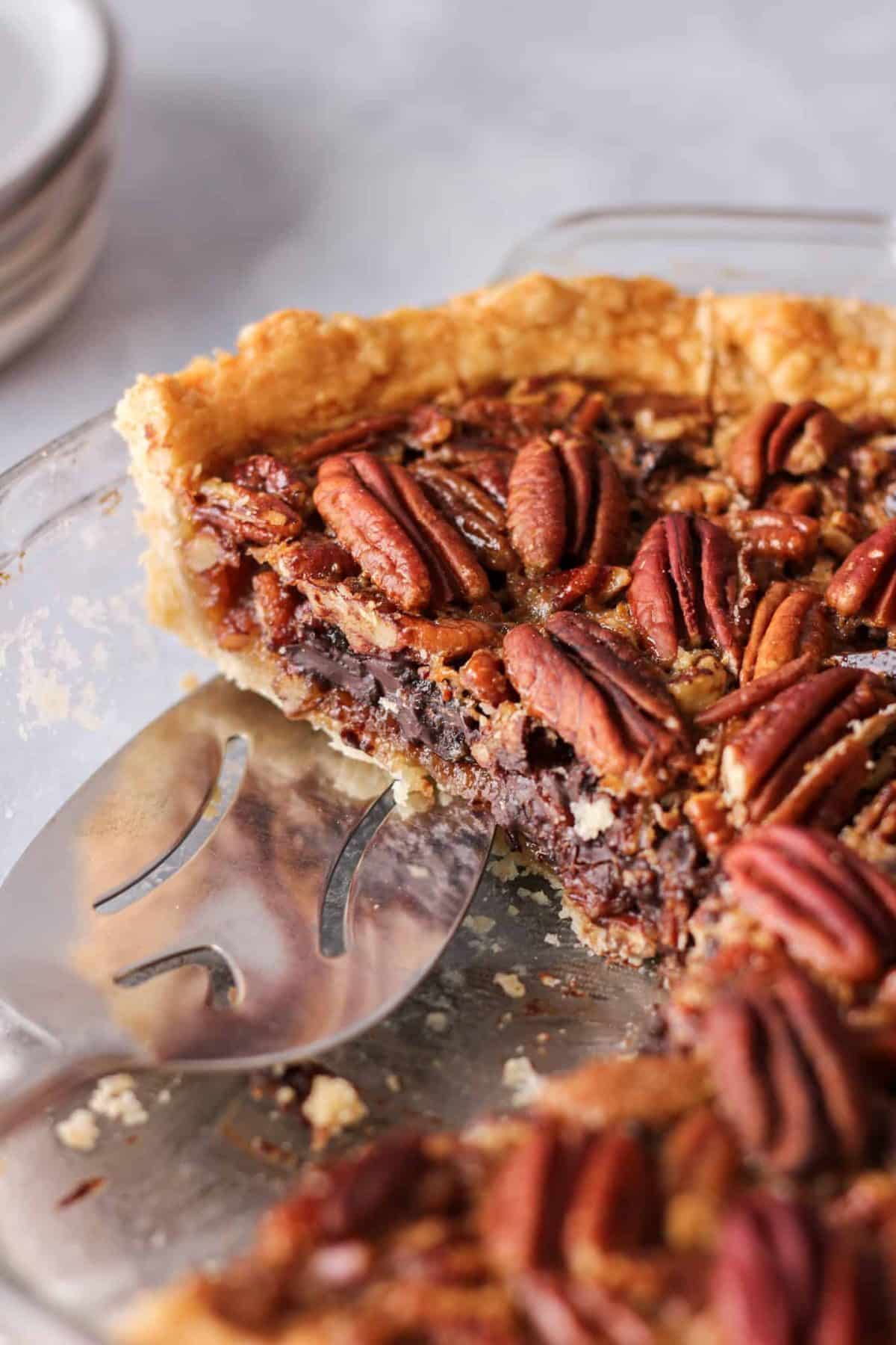 Dark chocolate bourbon pecan pie in a glass plate.