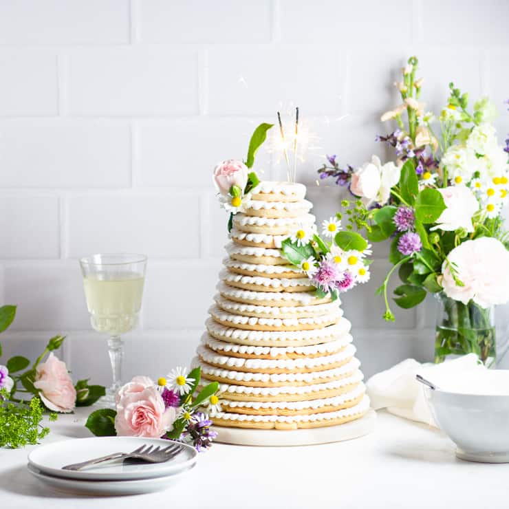 Tall Kransekake with layers with a variety of flowers.