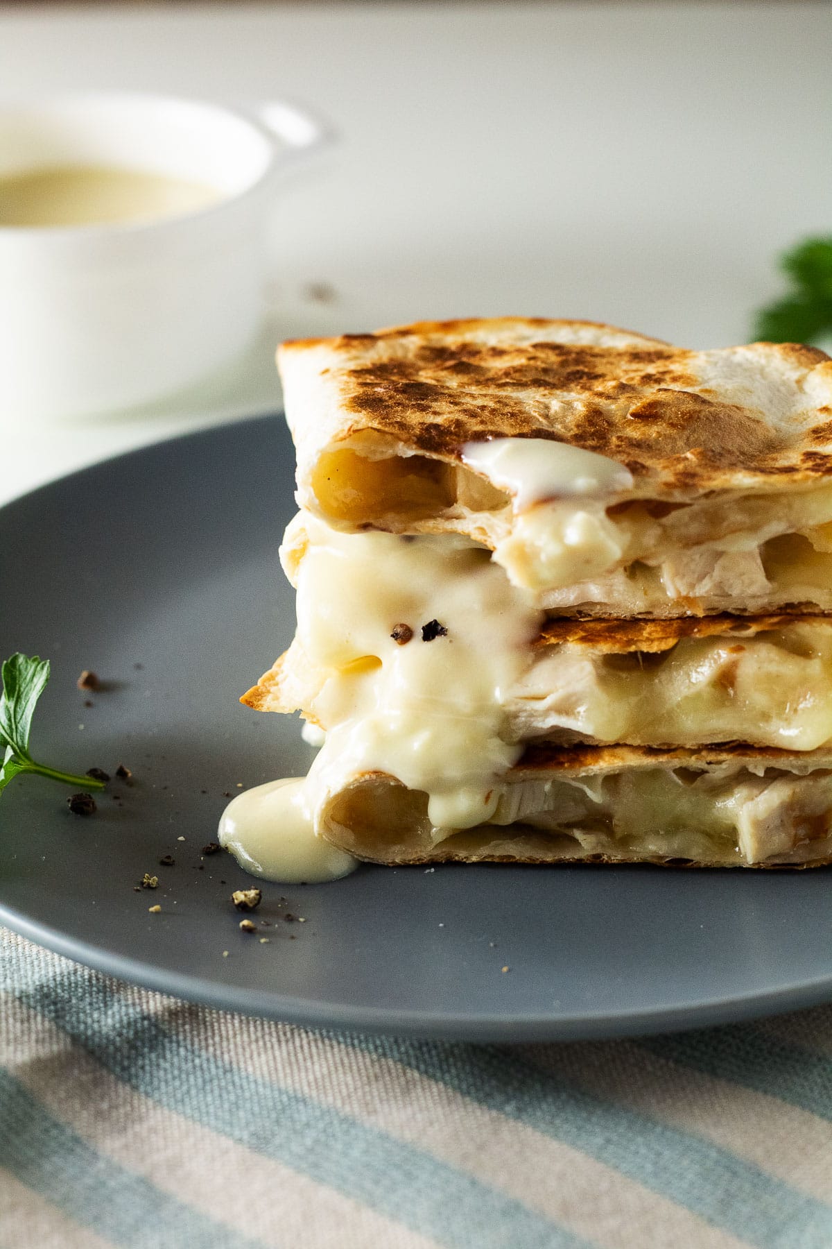 Stack of low carb chicken alfredo quesadillas on a blue plate.