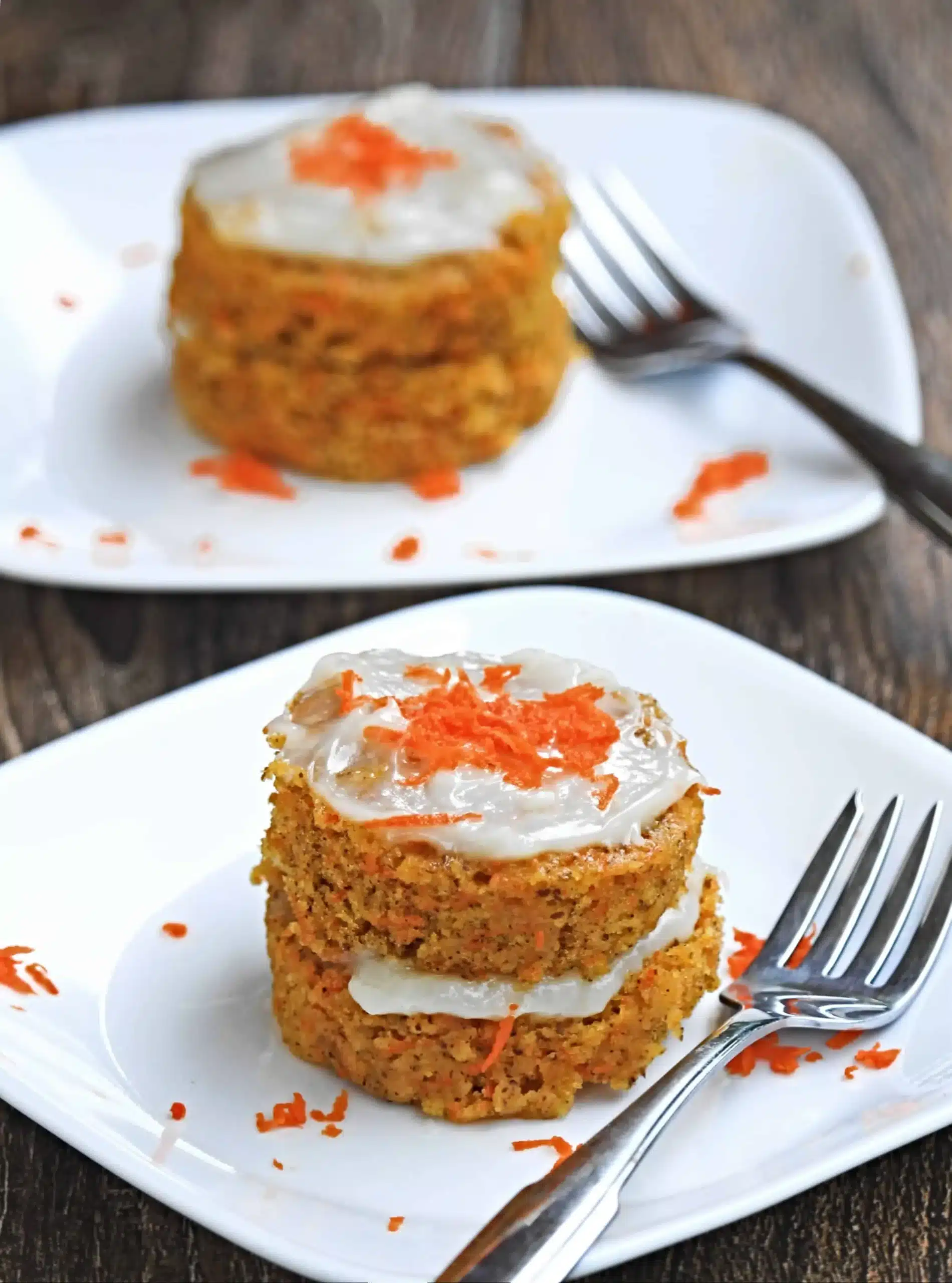 Double layer carrot mug cake on a square plate.