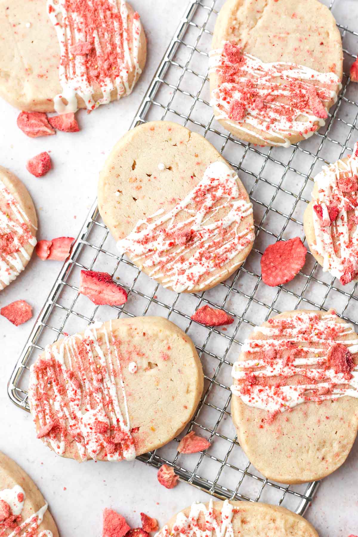 White chocolate strawberry cookies on a cooling rack.