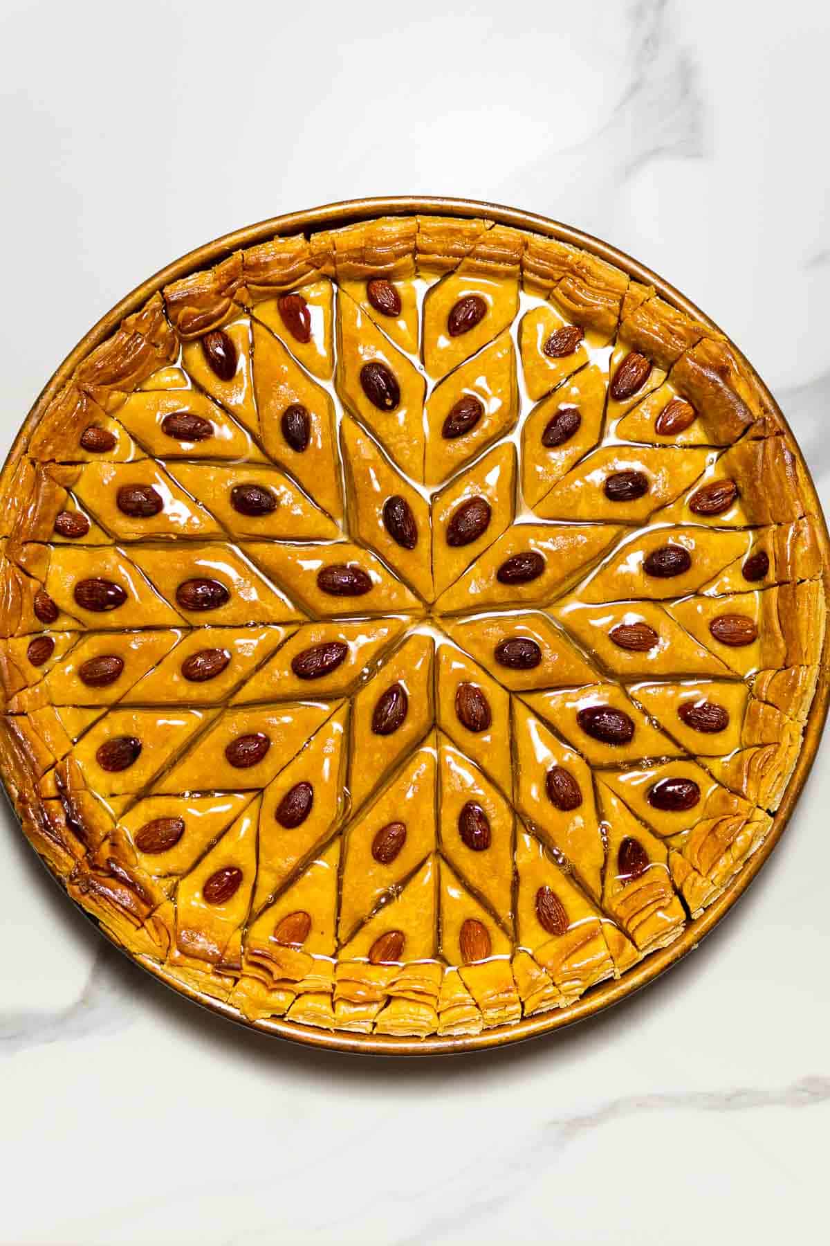 Turkish baklava recipe in a dish on a marble surface.