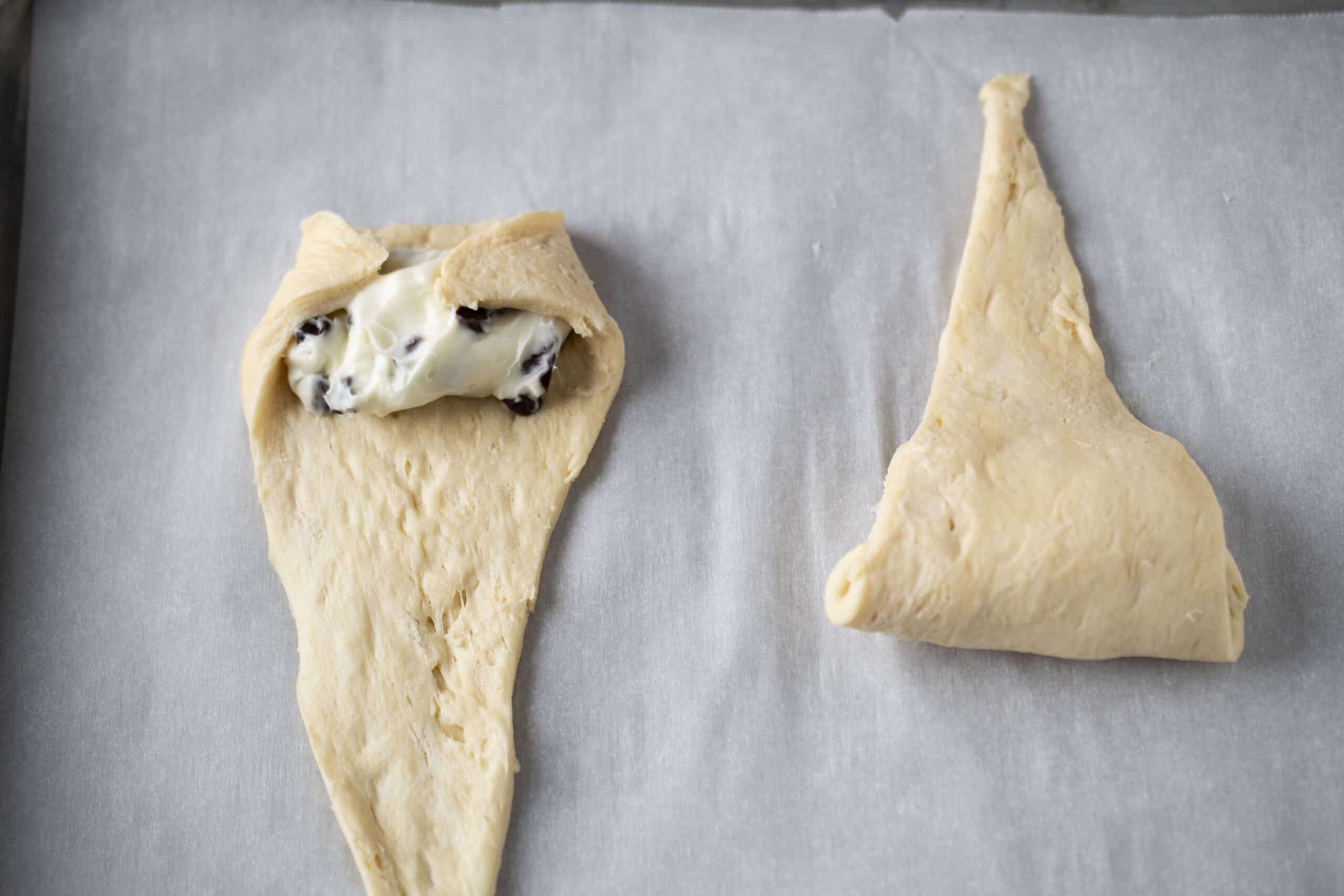 Rolling up the air fryer chocolate cheesecake croissants.