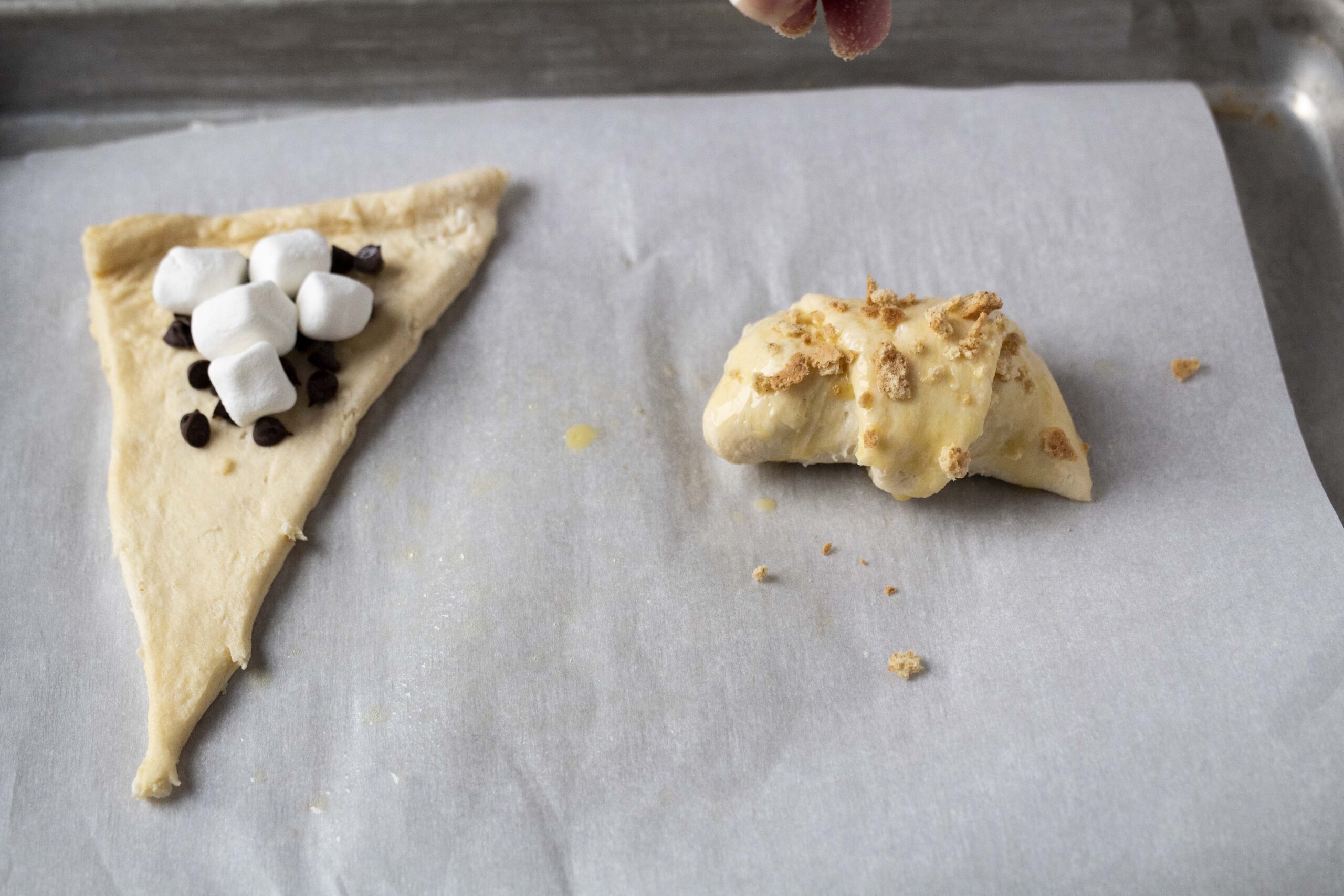 Crescent rolls with marshmallow and chocolate chips topped with graham cracker pieces.