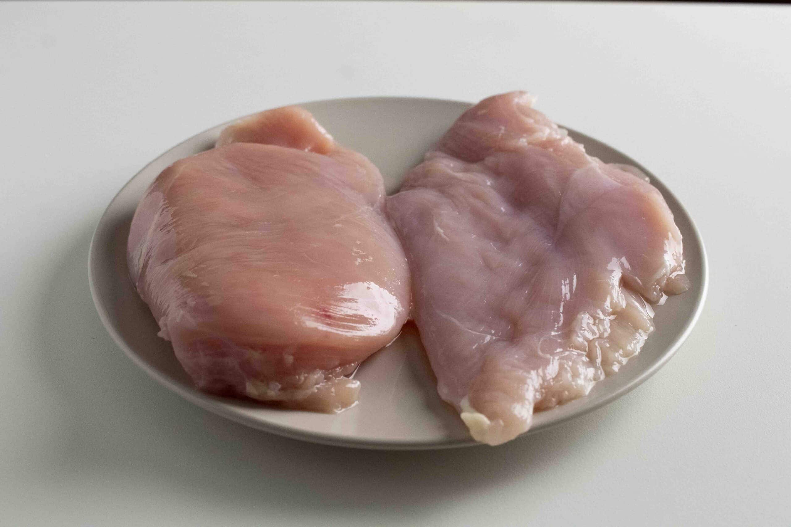 Before and after tenderizing chicken breast with a meat mallet.