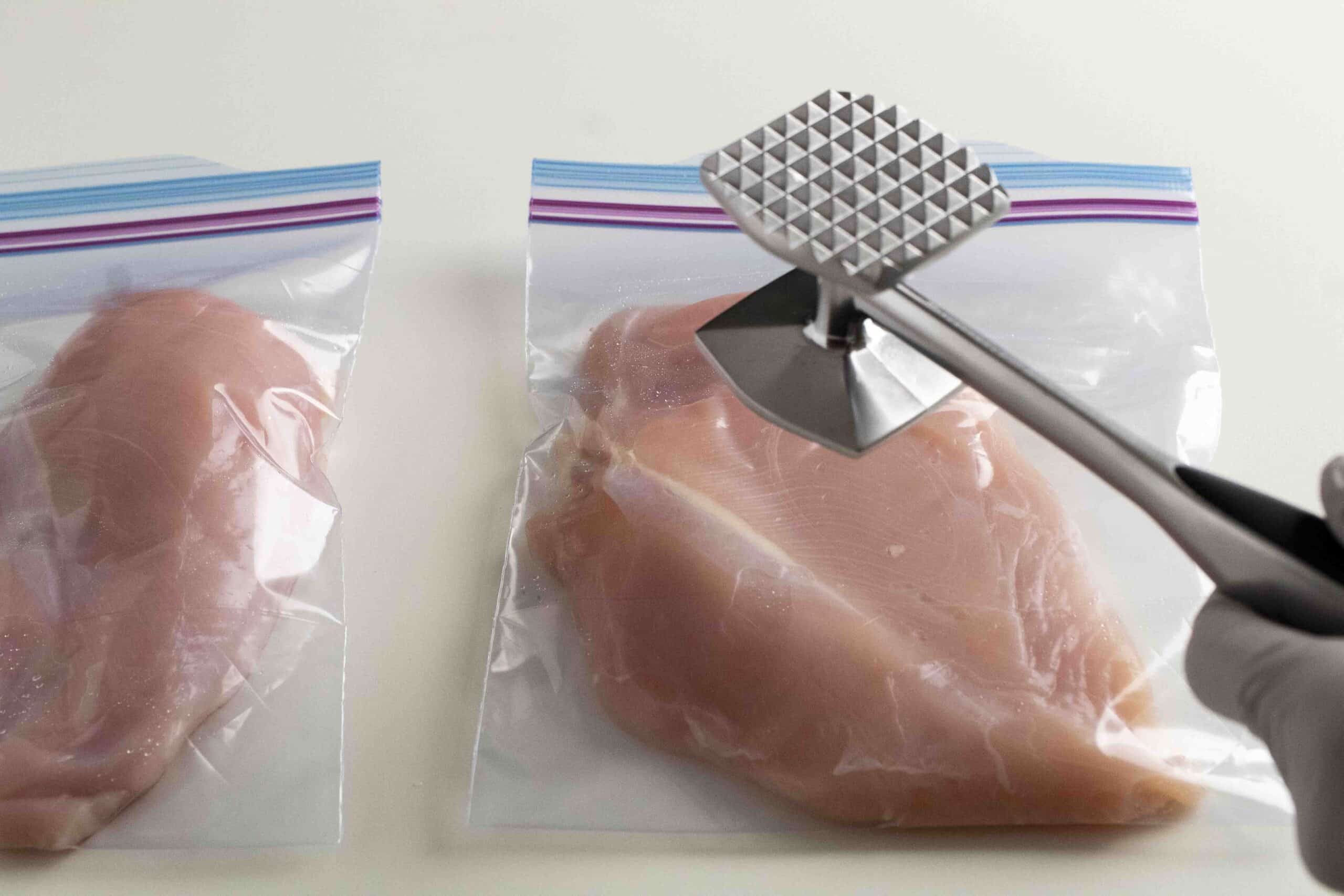 Tenderizing chicken breast with meat mallet.