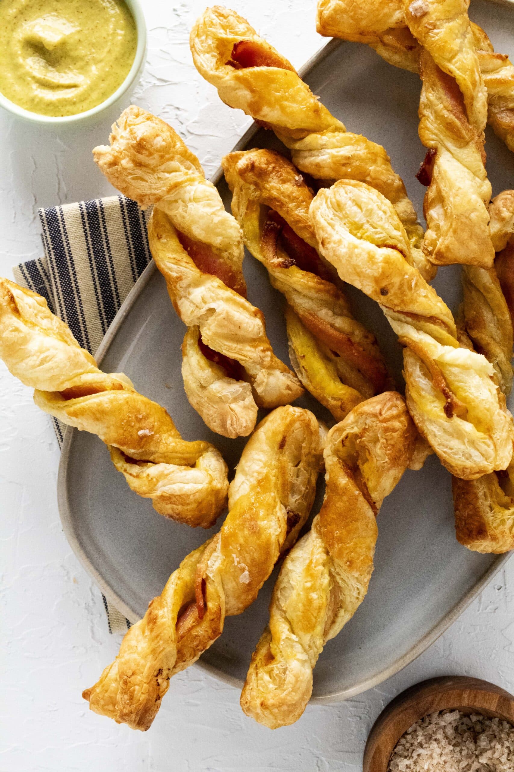 Air fryer puff pastry bacon twists on a platter.