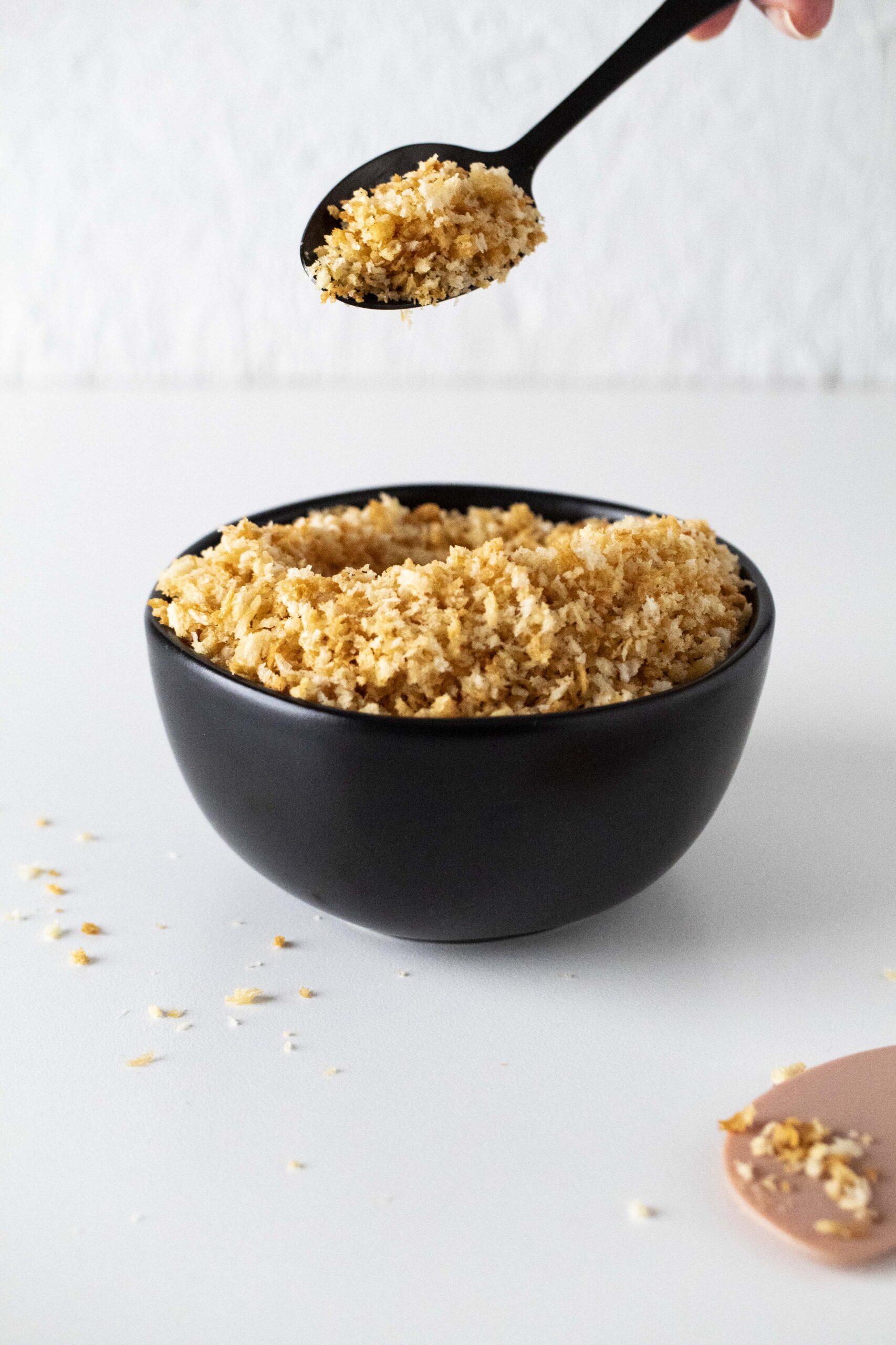 Toasted air fryer panko breadcrumbs in a black bowl.