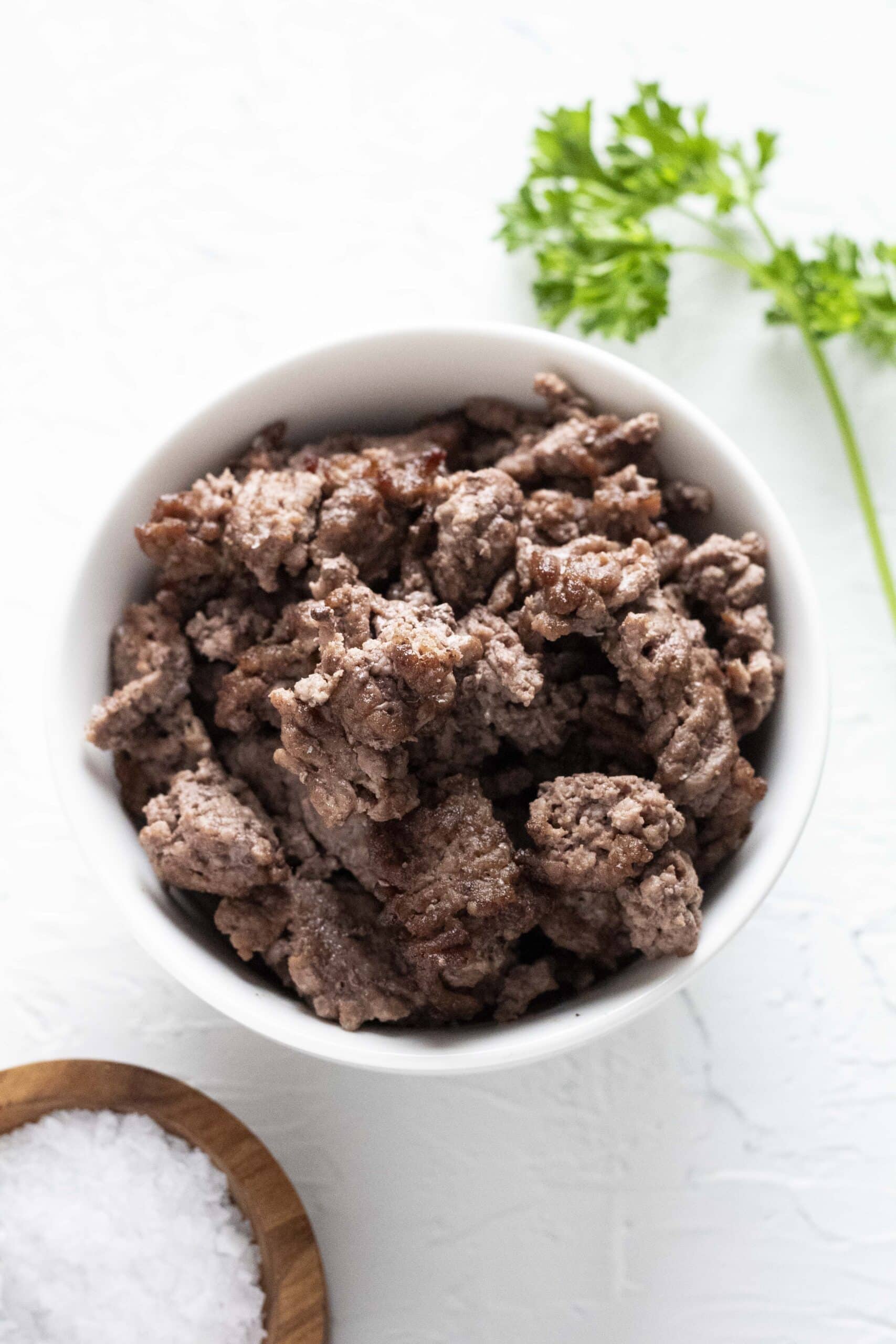 Air fryer ground beef in a white bowl.