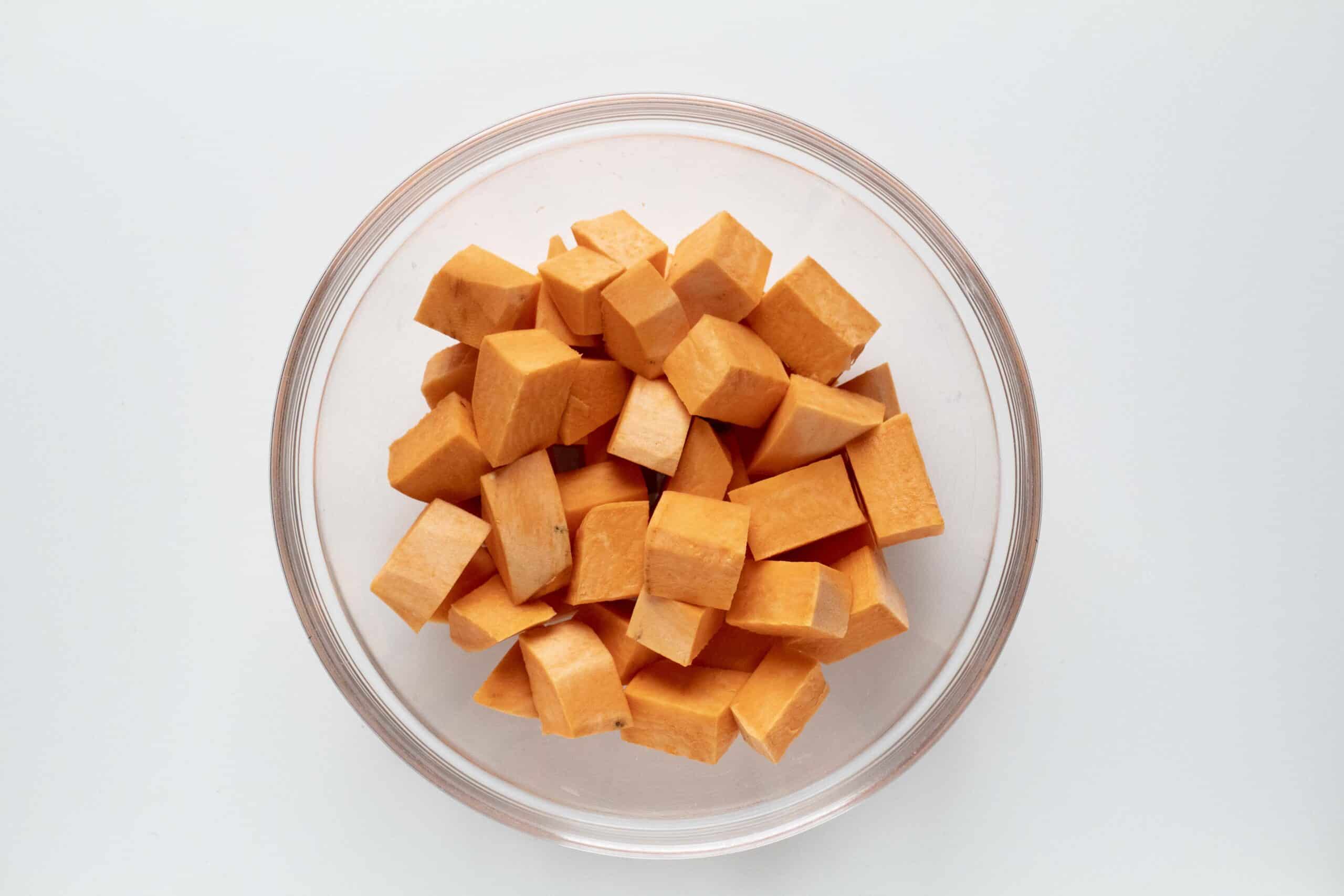 Diced sweet potatoes in a clear bowl.