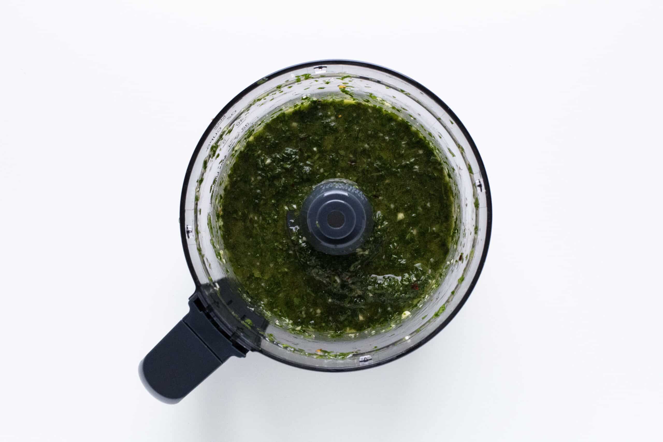 Chimichurri sauce blended in a food processor bowl.