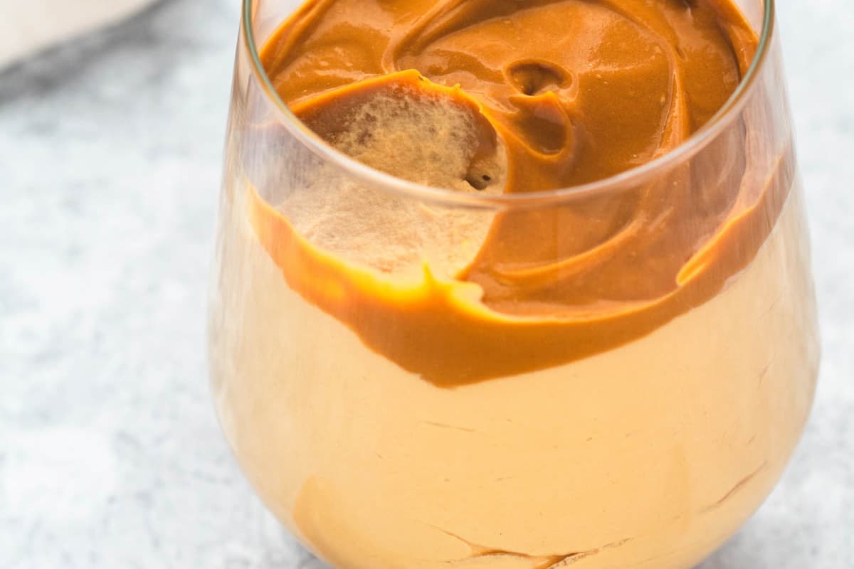 Dulce de leche mousse capped with more caramel in a glass.