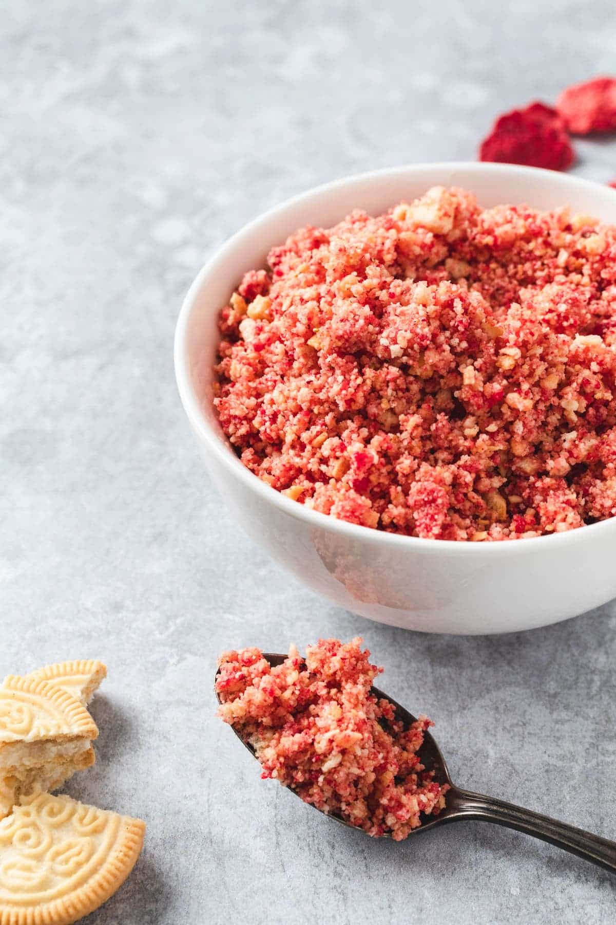 Strawberry crunch dessert topping in a white bowl.