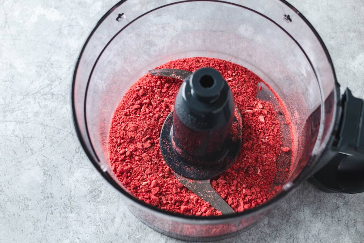 Pulverized freeze dried strawberries in a food processor bowl.