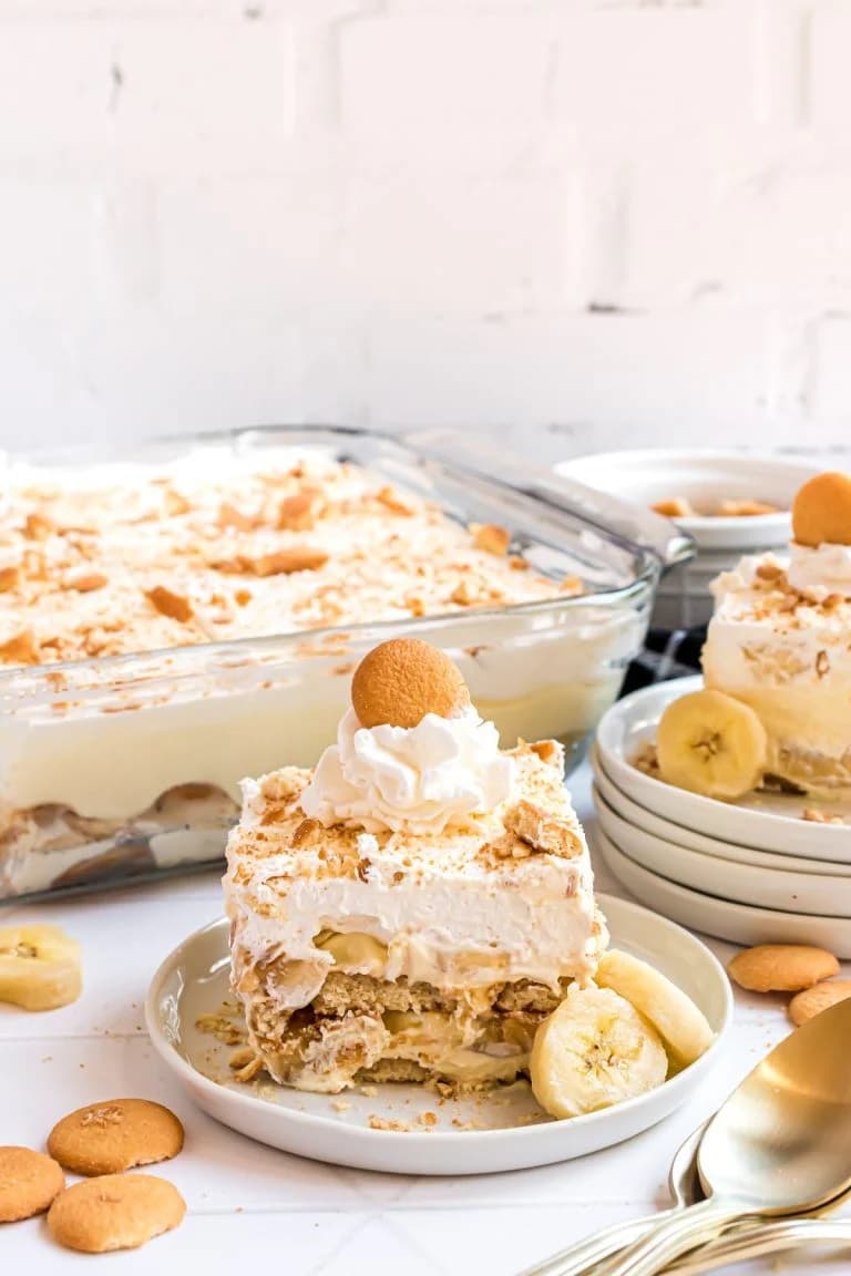 Creamy banana pudding layered with Nilla wafers and topped with whipped cream and a cookie.