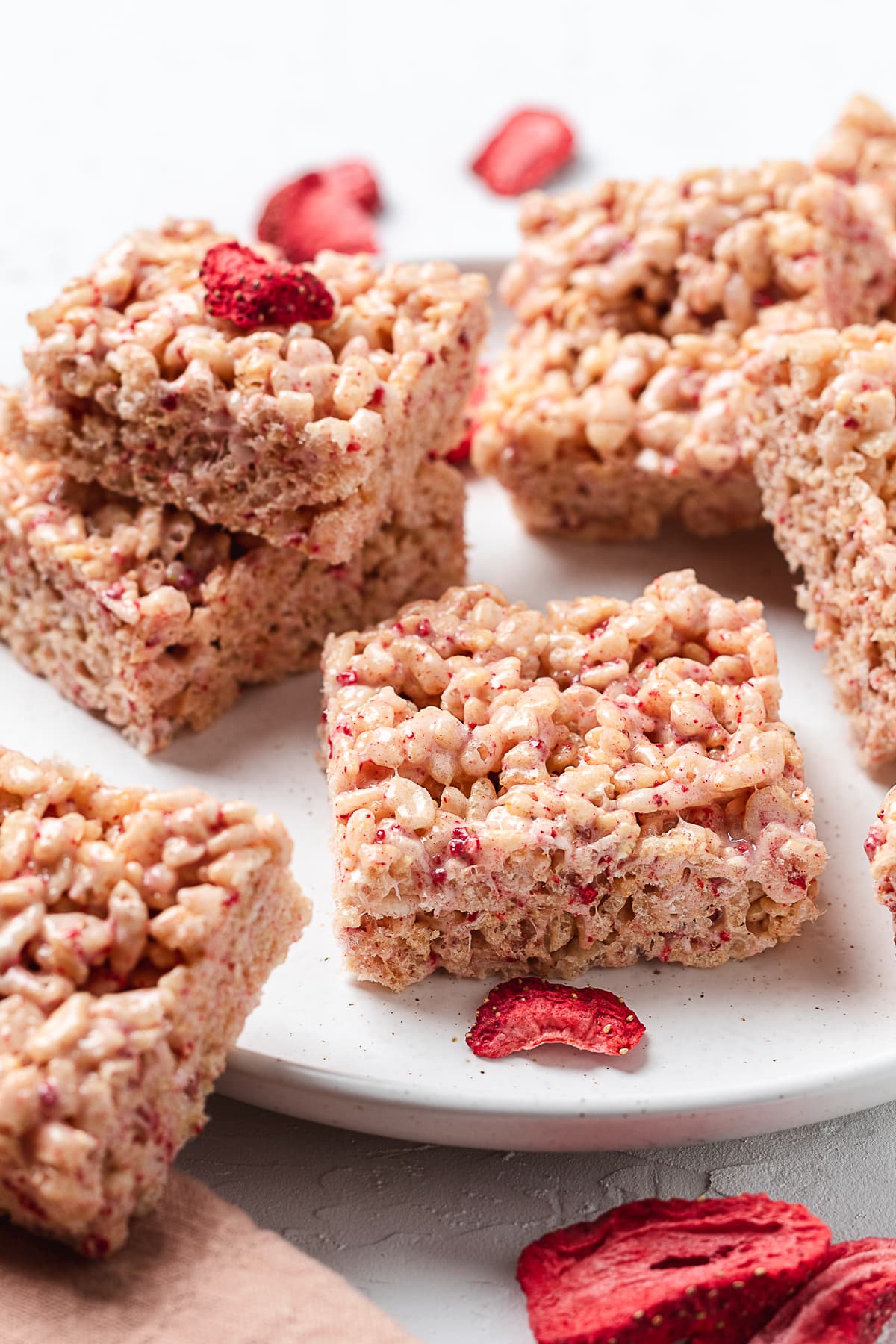 Strawberry rice Krispie treats on a white plate.